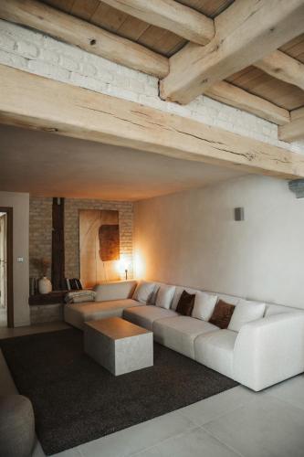 a living room with a couch and a table at Maison Aimée in Han-sur-Lesse