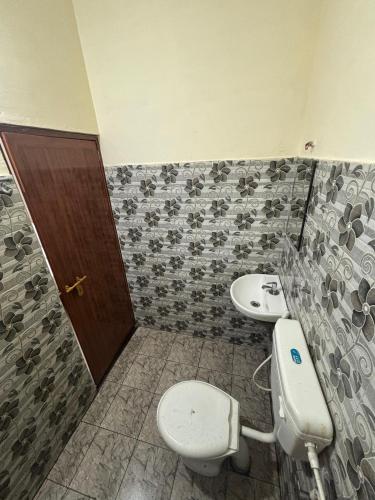 a bathroom with a toilet and a sink at Casa Grand in Alwaye