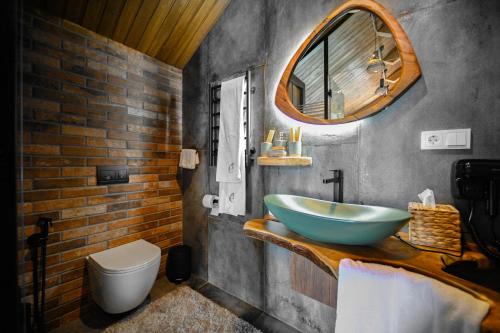a bathroom with a blue sink and a toilet at Escapes Boutique Hotel & Restaurant in Dilijan
