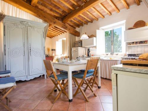 a kitchen with a white table and chairs at Holiday Home Villa Albertine by Interhome in Fattoria Spedaletto