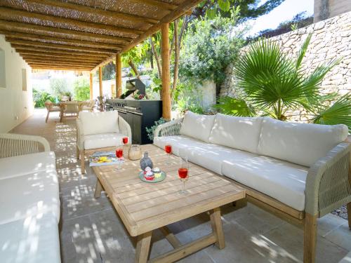 a patio with a white couch and a table at Villa Serenidad by Interhome in Casas de Torrat