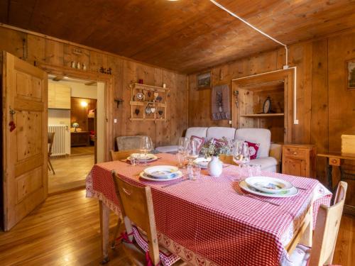 a dining room with a table with a red table cloth at Apartment Pozzaglio Mountain Home by Interhome in Valdisotto