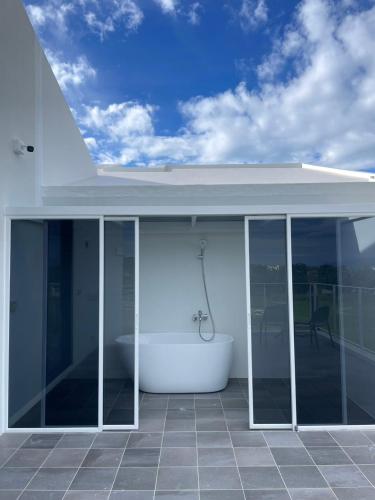 a bathroom with a bath tub on a house at 味知文旅 in Xiaoliuqiu