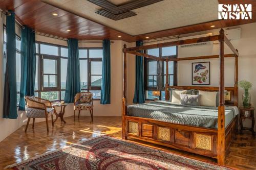 a bedroom with a bed and a desk with a table at StayVista at Lakeside Panorama with Lawn & Wi-Fi in Srinagar