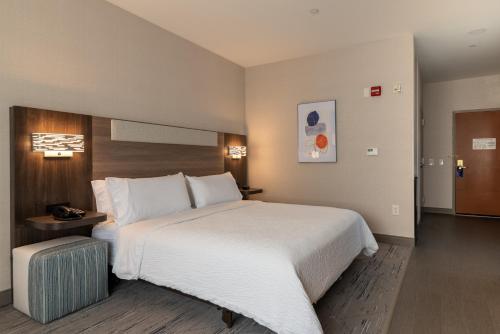 a hotel room with a large white bed in it at Holiday Inn Express Hotel & Suites Hampton South-Seabrook by IHG in Seabrook