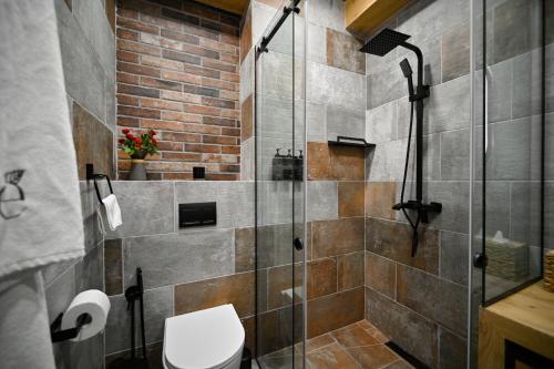 a bathroom with a glass shower with a toilet at Escapes Boutique Hotel & Restaurant in Dilijan