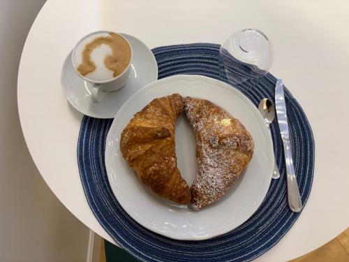 a plate with a pastry and a cup of coffee at Cielo B&B in Crotone