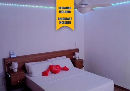 a bedroom with a bed with red pillows on it at Apartalux San Pedro Ático de Luna in San Pedro del Pinatar