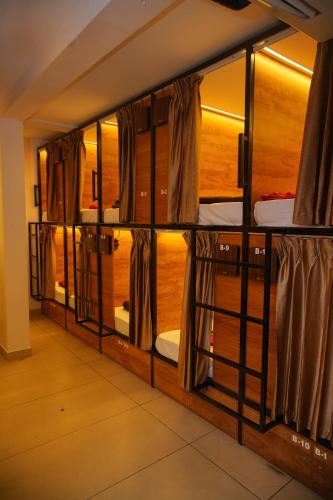a room with a bunk bed with windows at Stay Point Calicut Beach in Kozhikode