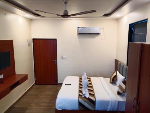 a hotel room with a bed and a ceiling fan at pushkar mountain valley in Pushkar