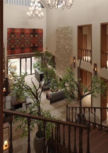 a living room with trees and a chandelier at Hills Hotel in Karakol