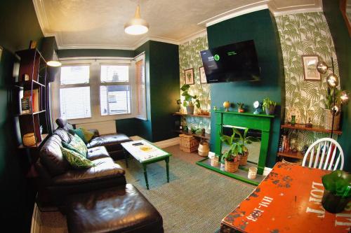 a living room with a couch and a table at Stylish and artistic flat in Southend on Sea in Southend-on-Sea