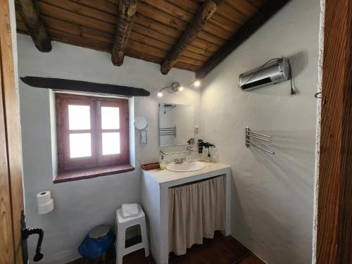 a bathroom with a sink and a window at Casa de la luz-Finca la Sierra in Berzocana