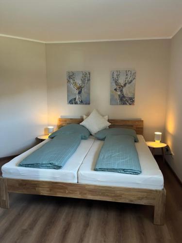 a bedroom with a large bed with two tables at Ferienwohnung Pommerbachquelle in Kaisersesch
