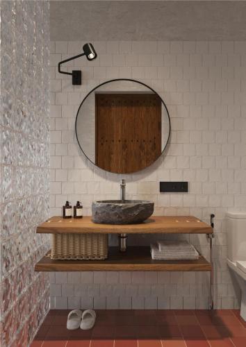 a bathroom with a sink and a mirror at Hills Hotel in Karakol