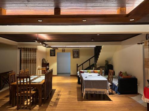 a living room with a table and a dining room at Selis Manor in Nuwara Eliya