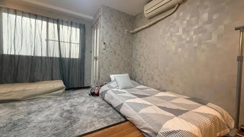 A bed or beds in a room at Osaka Umeda West JR Tsukamoto Inn CCCCC