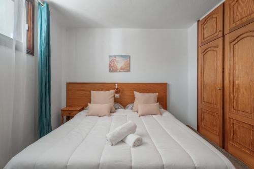 a bedroom with a large bed with two pillows on it at Las Floritas in Playa de las Americas