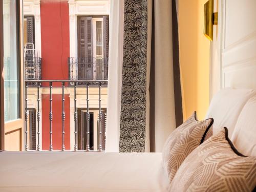 a bedroom with a view of a balcony at Ópera Stays by Charming in Madrid