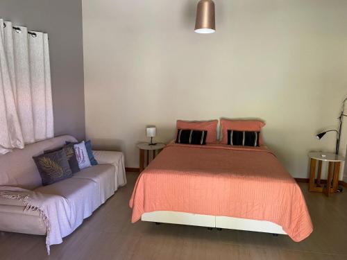 a bedroom with a bed and a couch at Pousada Destino in Porto de Sauipe