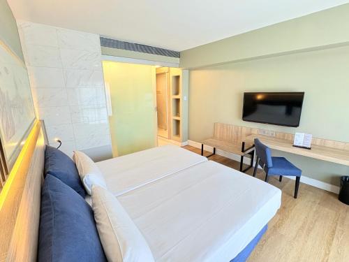 a bedroom with a bed and a desk and a tv at Eurohotel Barcelona Granvia Fira in Hospitalet de Llobregat