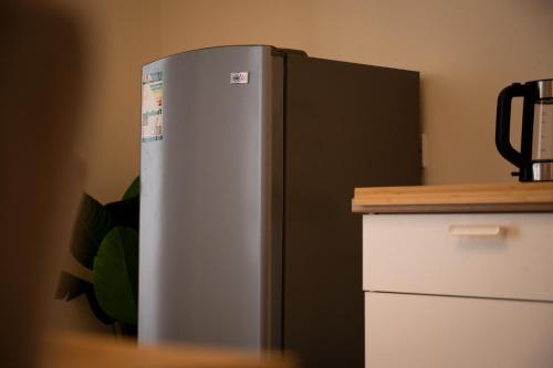 a stainless steel refrigerator in a kitchen with a counter at جناح بانورامي in Jeddah