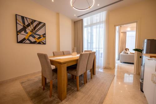 a kitchen and dining room with a wooden table and chairs at جناح بانورامي in Jeddah