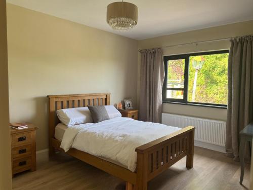 a bedroom with a large bed and a window at Riversdale Road Tyrone Omagh Fermanagh in Drumquin