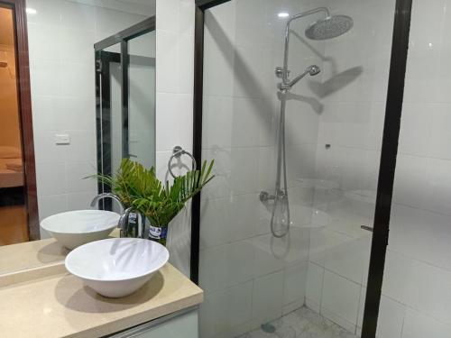 a bathroom with two sinks and a shower at Large 4 Bedroom 7 Bed Villa in Sonaisali Rd, Nadi in Nadi