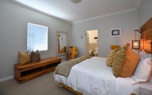 a bedroom with a large bed and a window at Apartment 6 in Yzerfontein