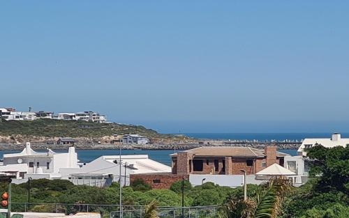 a group of white buildings and a body of water at Apartment 6 in Yzerfontein