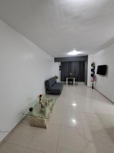 a living room with a couch and a table at Ocean View Two Bedroom in Porlamar
