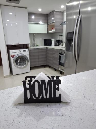 a home sign on a counter in a kitchen at Ocean View Two Bedroom in Porlamar
