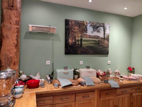 a kitchen with a counter with food on it at Hotel B&B Hoeve de Vredenhof in Zuidlaren