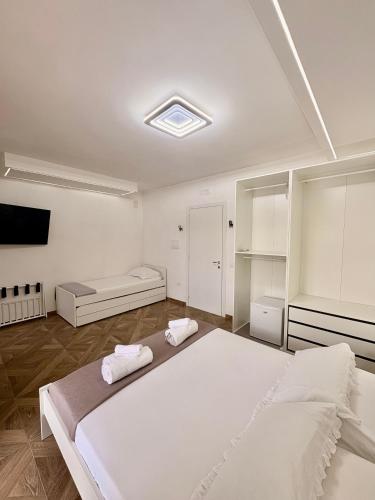 a bedroom with a large bed with two towels at Maison24 in Martinsicuro