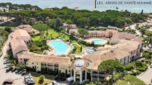 an aerial view of a resort with a swimming pool at Hôtel Les Jardins De Sainte-Maxime in Sainte-Maxime