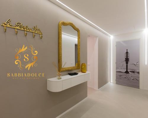 a dressing room with a mirror and a sink at Sabbiadolce in Bellaria-Igea Marina