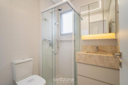 a bathroom with a shower and a toilet and a sink at Apt w/ balcony and grill 220m from the Sea ALB0201 in Florianópolis