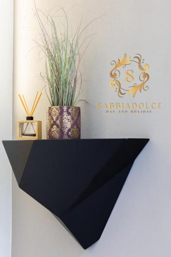 a sign for a spa catalogue with a plant at Sabbiadolce in Bellaria-Igea Marina