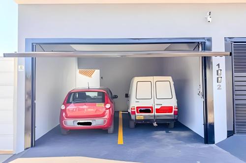 a car garage with two cars parked in it at Vila São José 1 in Ourinhos