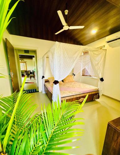 a bedroom with a bed with a mosquito net at Elure Stays in Pātalpāni
