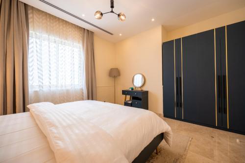 a bedroom with a large bed and a window at جناح بانورامي in Jeddah