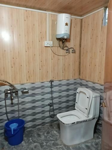 a bathroom with a toilet and a shower at Bloomfield Farmhouse 2 in Darjeeling