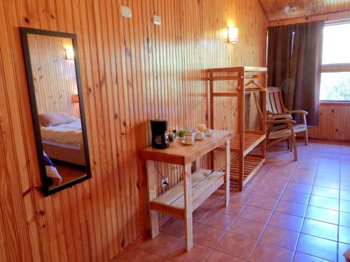 a room with a bunk bed and a table and a mirror at Miztli Lodge & Adventure in Monteverde Costa Rica