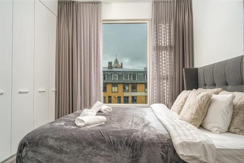 a bedroom with a bed with a teddy bear on it at Unbeatable Central Location - Reykjavíks Most Exclusive Luxury Apartments in Reykjavík