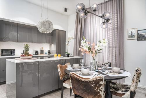 a kitchen and dining room with a table and chairs at Unbeatable Central Location - Reykjavíks Most Exclusive Luxury Apartments in Reykjavík
