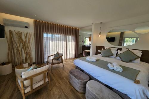 a hotel room with a large bed and a chair at Marinha Grande Apartamentos Rainbow N9 in Marinha Grande