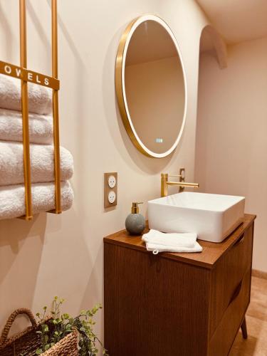 a bathroom with a sink and a mirror at LoveRoom, La suite de l’extase in Puget-sur Argens