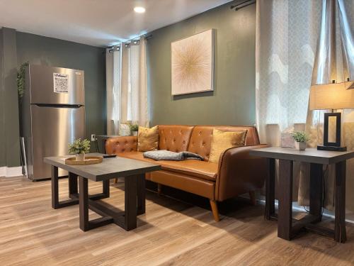 a living room with a couch and two tables at Chandler Studio Apartments in Evansville