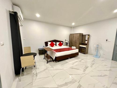 a bedroom with a bed with red pillows on it at PR ROOM FOR RENT in Kamala Beach